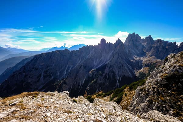 Breathtaking view of the Dolomites mountain peaks under a clear blue s