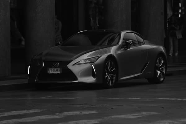 Sleek Lexus captured in black and white on a quiet street in Turin, It
