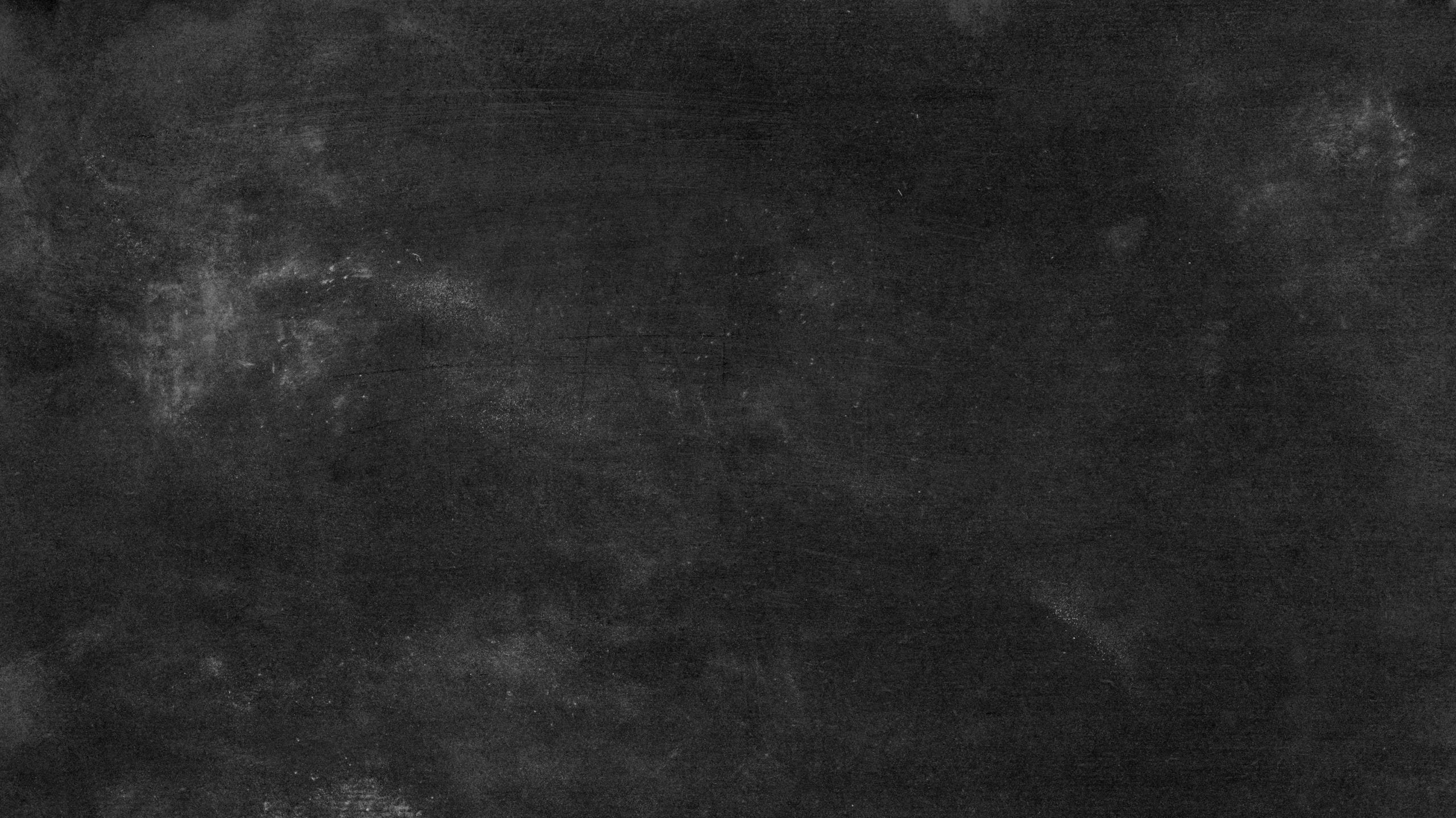 High-resolution texture of an empty black chalkboard surface for desig