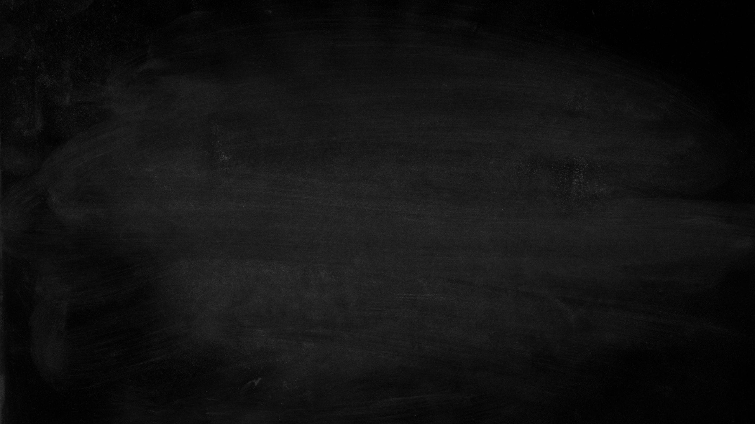A simple black chalkboard displaying erased chalk marks. Perfect for e