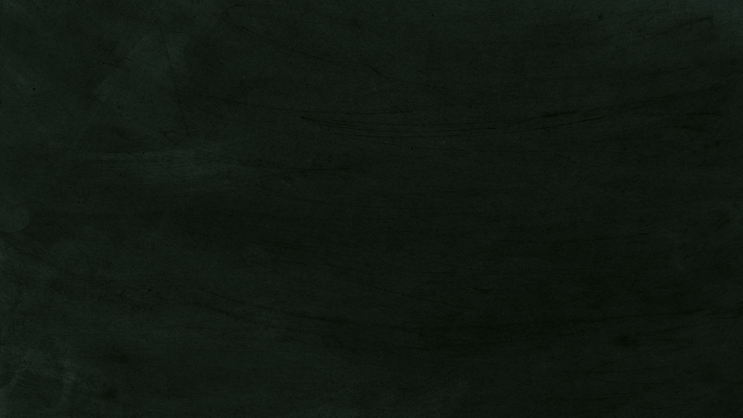 Black chalkboard texture with various chalk marks and scratches.