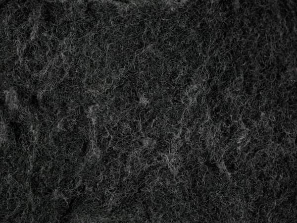 Detailed texture of a black dish sponge captured in macro photography,