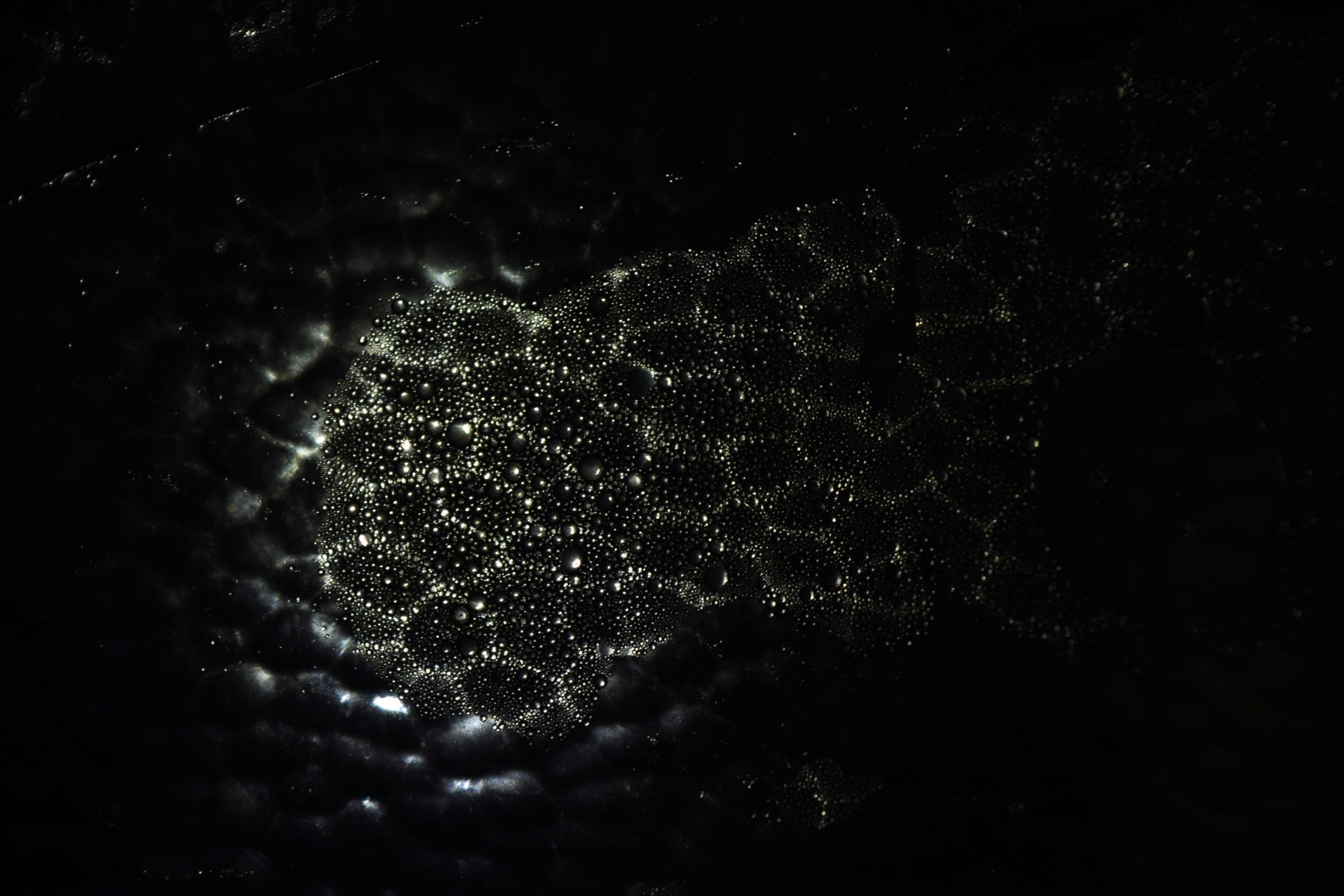 Intriguing abstract pattern of light and shadow on a dark background,