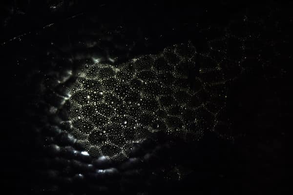 Intriguing abstract pattern of light and shadow on a dark background, 