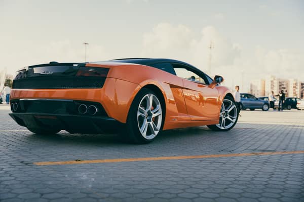 Vibrant orange Lamborghini Gallardo parked outdoors in Benghazi, Libya