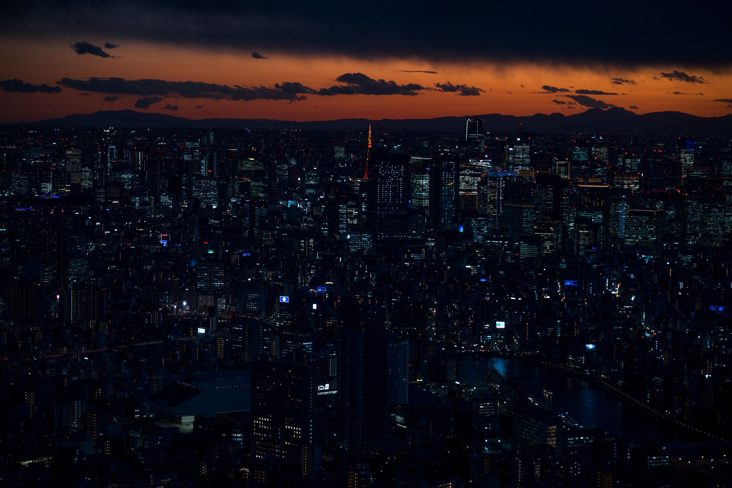 A stunning twilight view of Tokyo's vibrant cityscape featuring iconic