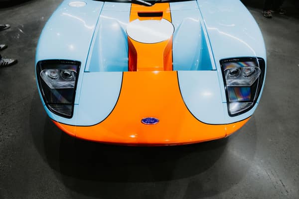 Front view of a vintage blue and orange sports car, showcasing its ico