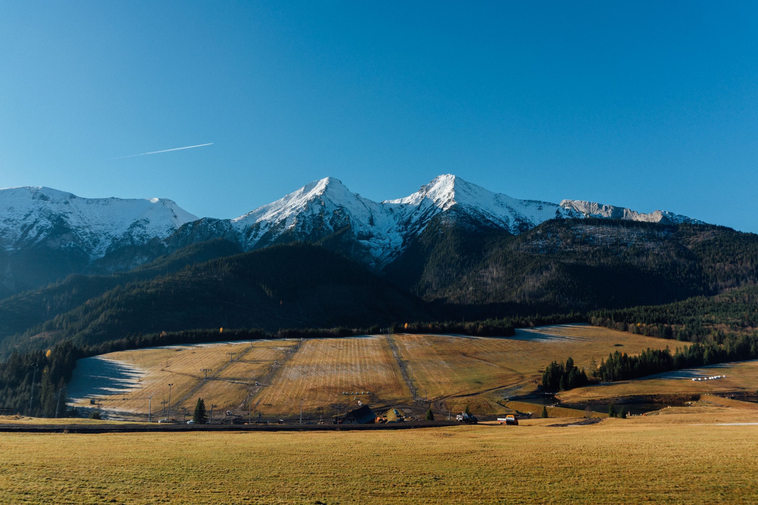 Breathtaking panoramic view of the snow-capped mountains and open fiel