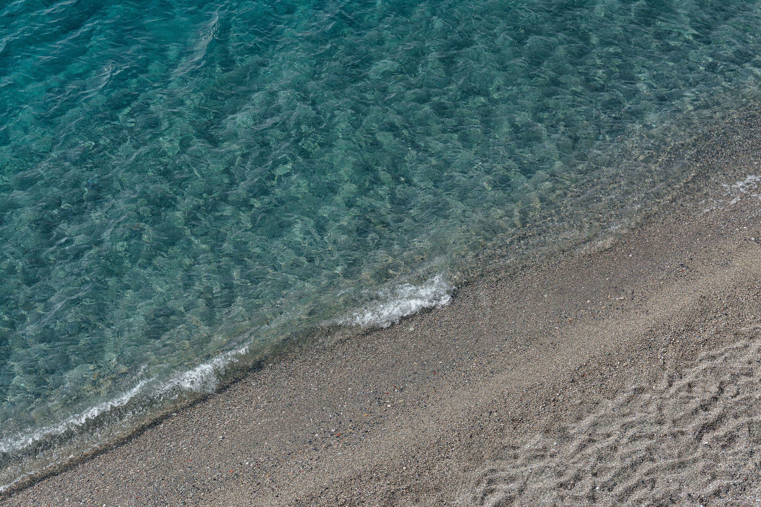 A serene beach scene with gentle waves meeting the sandy shore, perfec