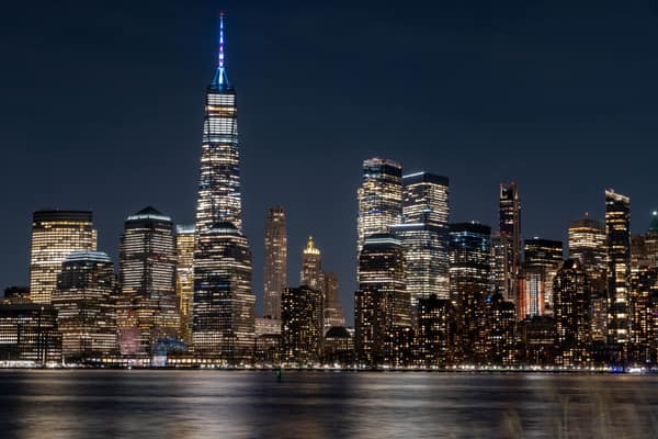 Illuminated New York City skyline featuring the iconic One World Trade