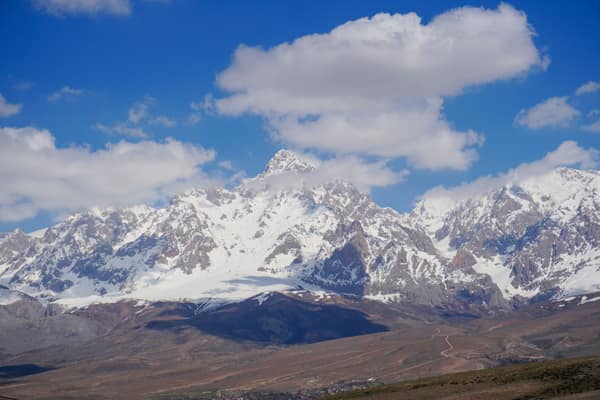 Experience the majestic beauty of the snow-capped mountains, under a c