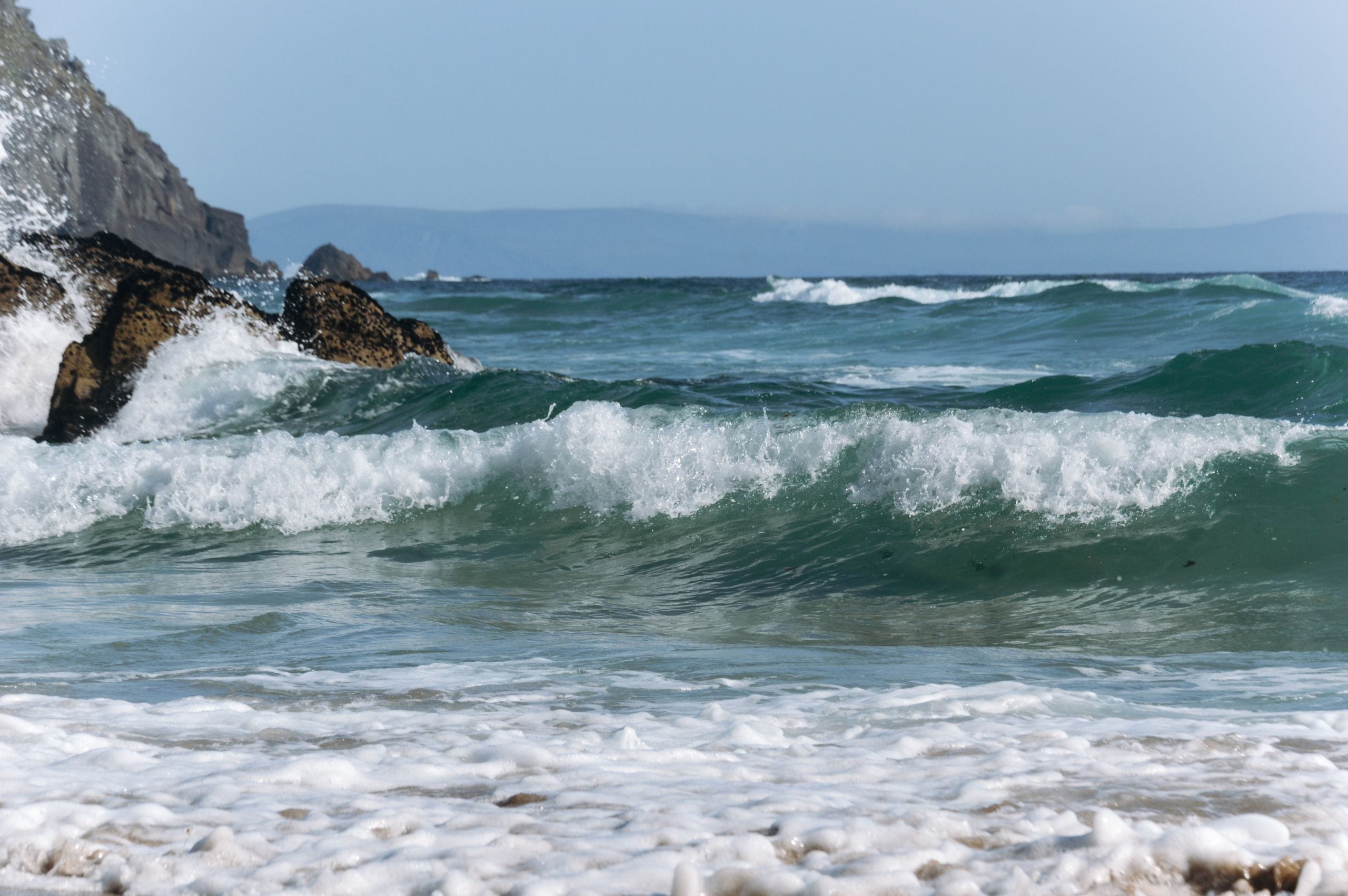 Captivating ocean waves hitting a rocky shore in County Kerry, Ireland
