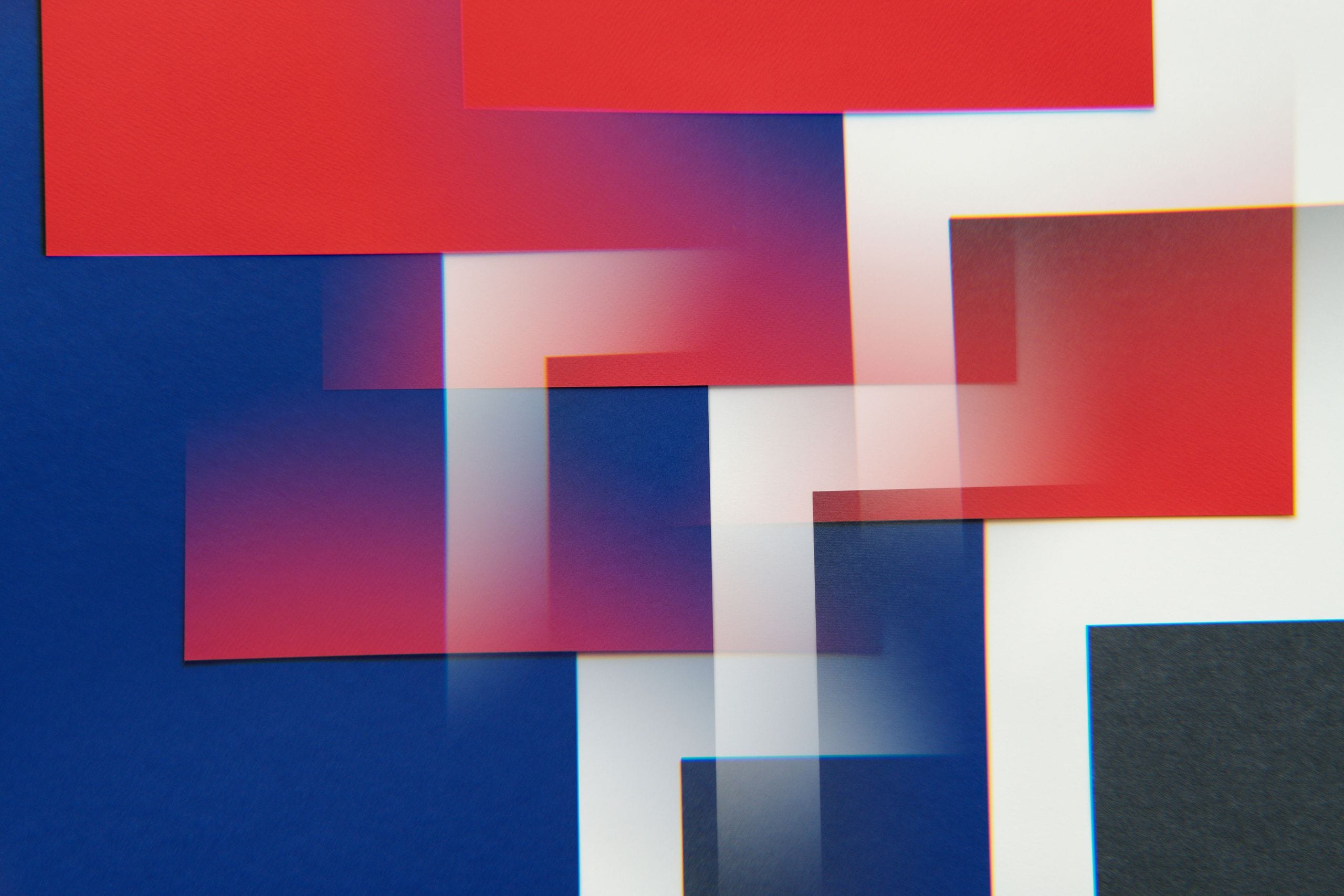 Dynamic abstract image featuring overlapping red, blue, and white rect
