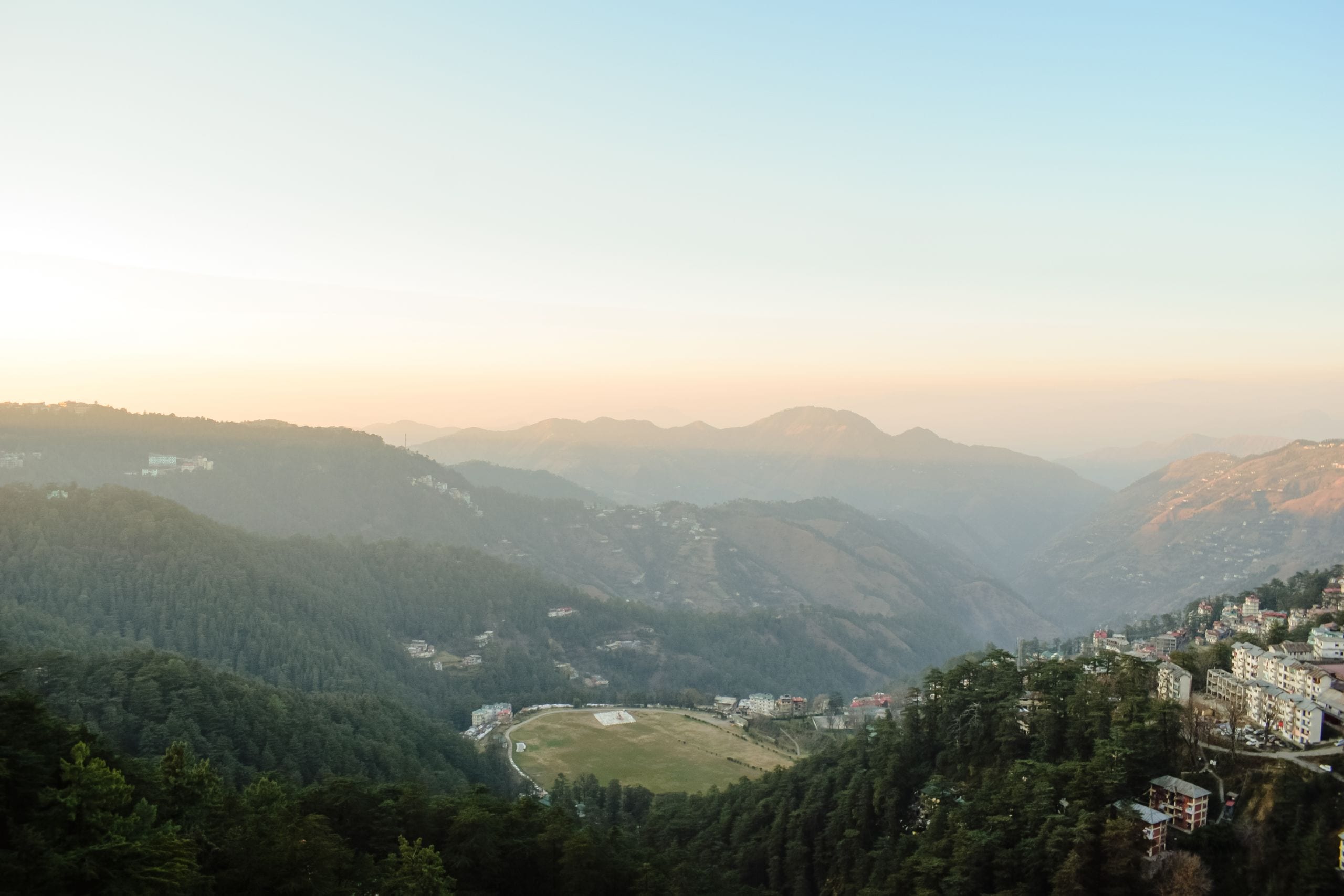 Stunning aerial view of a misty mountain valley at sunrise, capturing