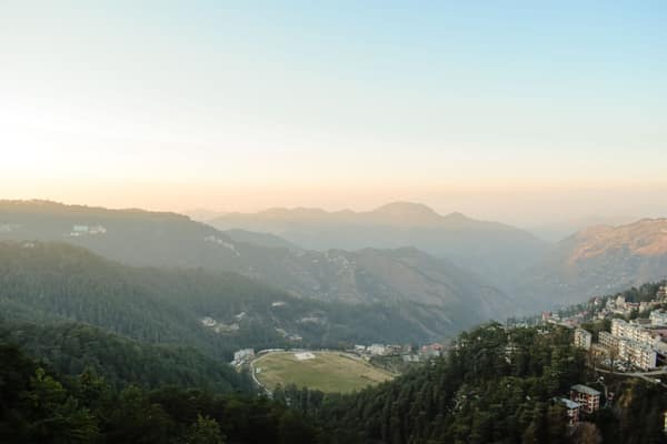 Stunning aerial view of a misty mountain valley at sunrise, capturing 
