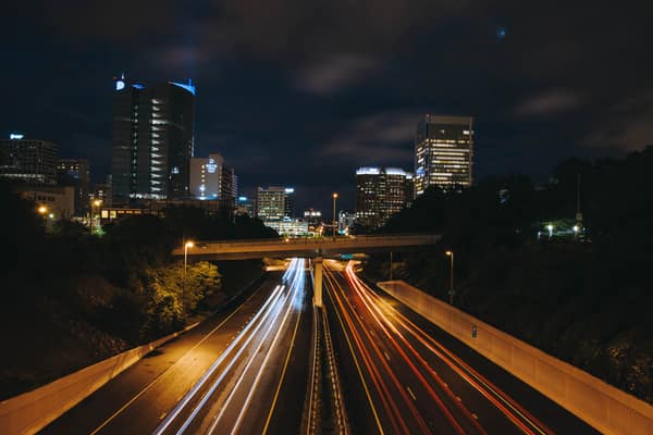 Dynamic night view of an urban highway with light trails and illuminat