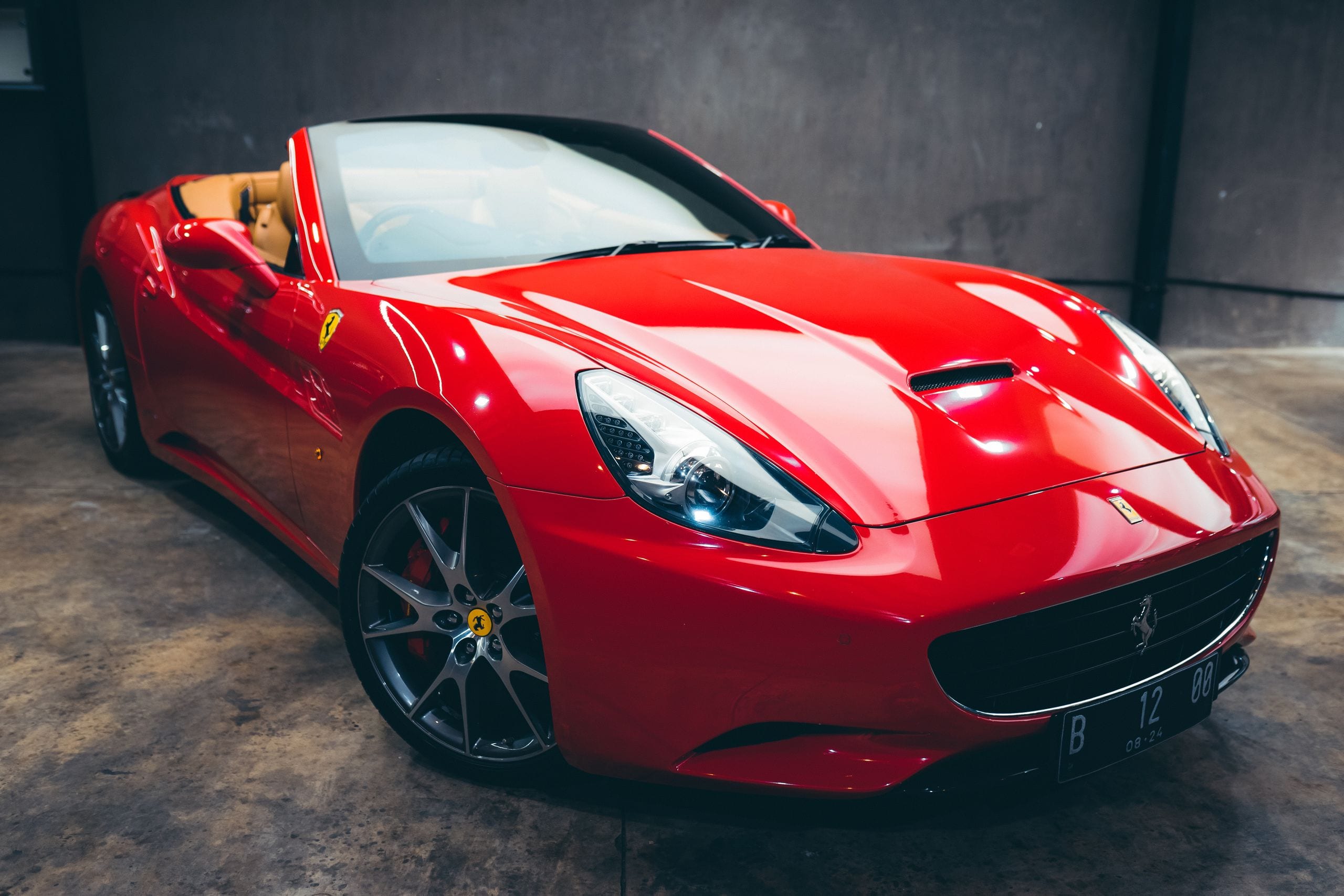 Expensive glossy red convertible with polished body parked in garage w