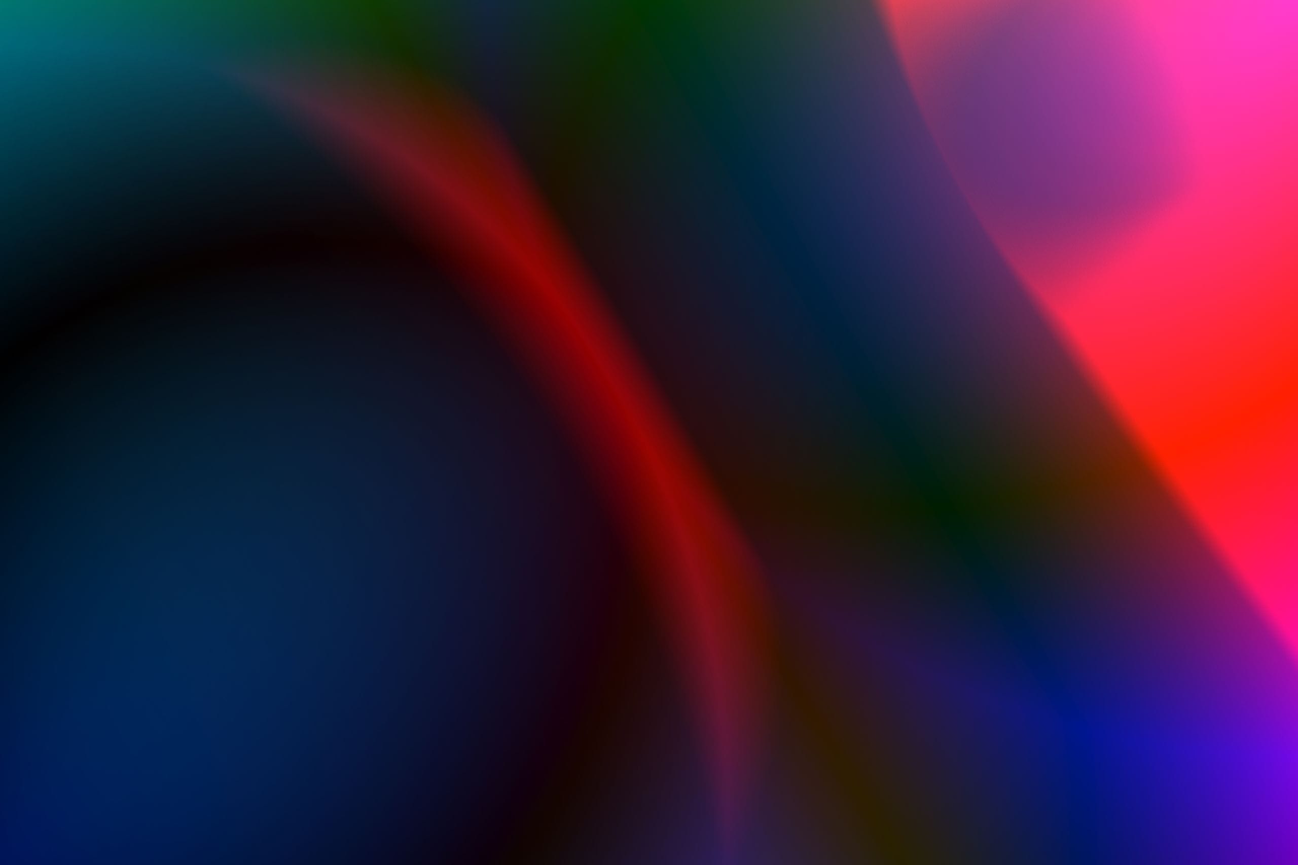 A dynamic and colorful abstract gradient background with flowing hues