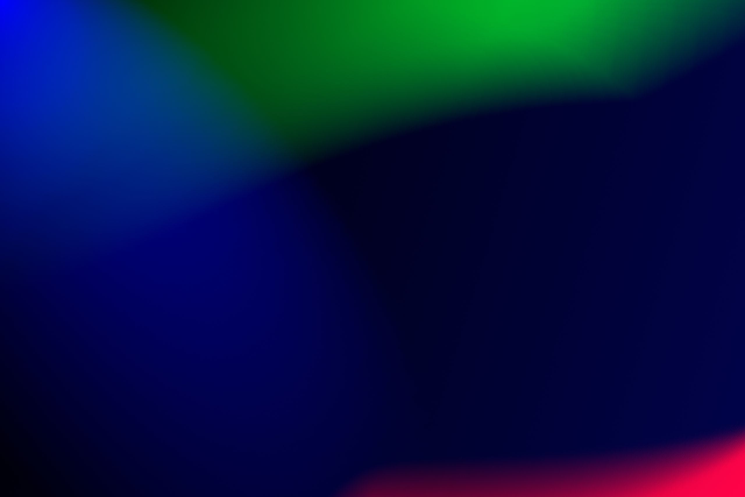 Vivid abstract gradient background with blue, green, and red hues. Ide