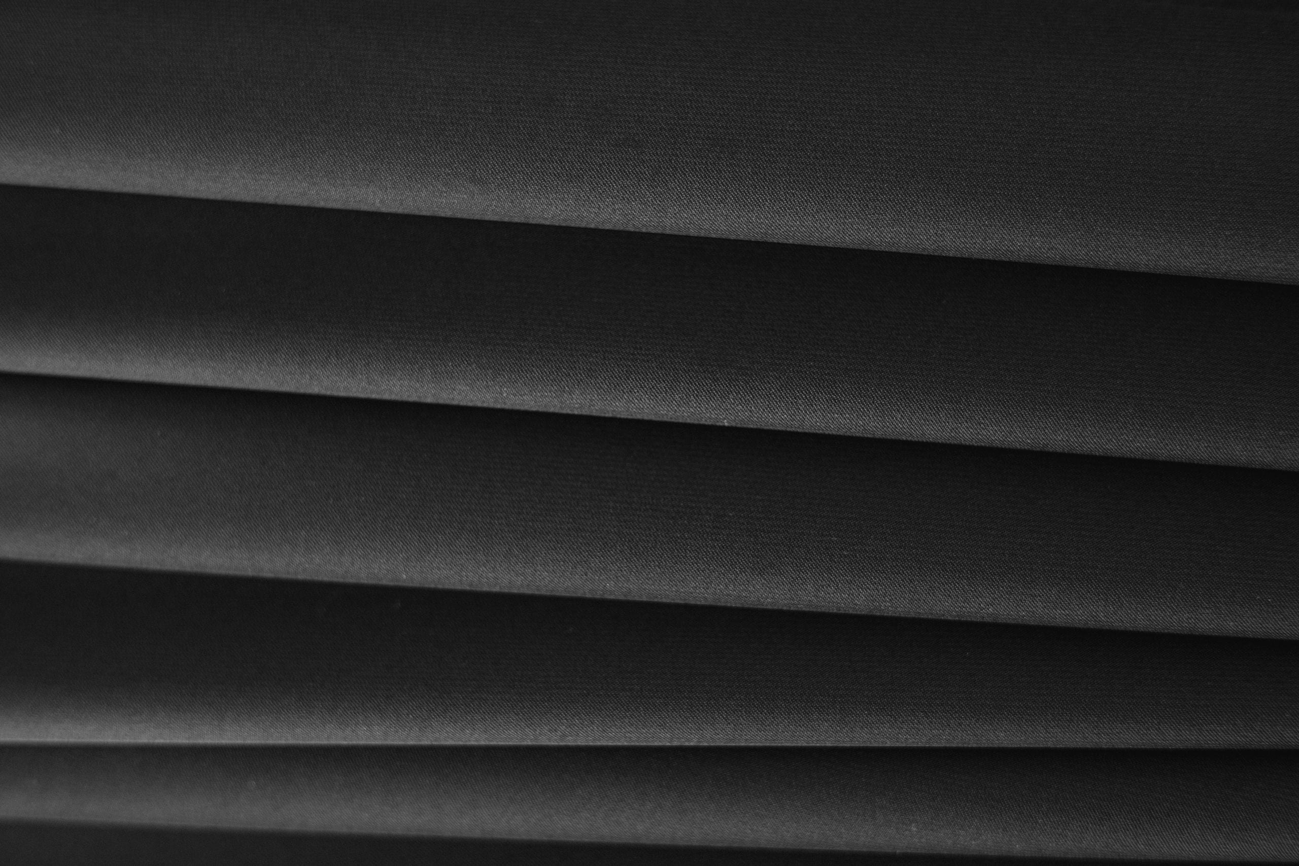 Detailed close-up of sleek black textile fabric showcasing texture and
