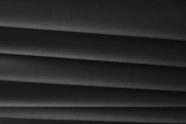 Detailed close-up of sleek black textile fabric showcasing texture and